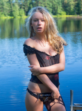Young lady in net pantyhose at the lake
