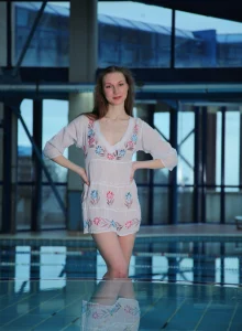 Flexible nude baby with puffy nipples is in the pool