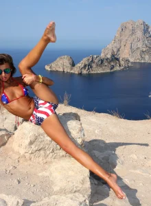 Micro bikini beauty strips at the rocks by the sea