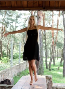 Sexy blonde visiting summer house in black dress