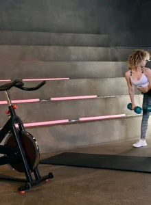 Sexy fitness baby in motley spandex doing exercises
