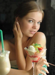 Sweet girl poses backyard clothing green and white summer dress