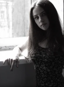 Young goddess in tiny black see-through dress and nude